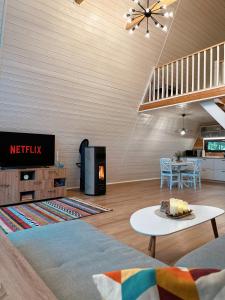 a living room with a tv and a table at Aret House in Avrig
