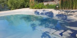 a pool of blue water in a yard at Il Casale di Lucullo-Holiday Home with Pool and Spa- in Lucignano