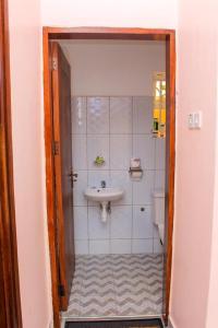 a bathroom with a sink and a toilet at POPPI HOUSE 3 bedroom in Kampala