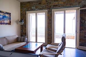 a living room with a couch and a coffee table at Levander Stone House in Gavrio