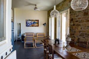 a dining room with a wooden table and chairs at Levander Stone House in Gavrio