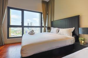a bedroom with a large bed with a large window at The Mews KLCC by GB in Kuala Lumpur +272 photos