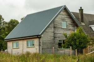 a house with a solar roof on it at Taigh Geal Apartment in Portree