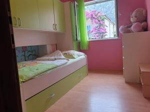 a small bedroom with a bed and a window at Apartment LoLi in Orebić