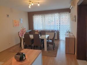 a dining room and living room with a table and chairs at Apartment LoLi in Orebić