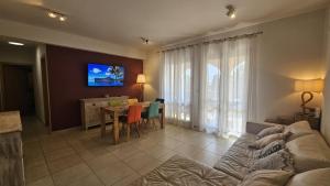 a living room with a couch and a table at STAY Aphrodite Hills Apartment in Kouklia