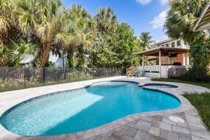 a swimming pool in the backyard of a house at Palm City Home with Pool and Florida Room - Near Golf in Stuart