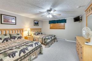 a bedroom with two beds and a ceiling fan at Snowshoe Condo with Mtn Views, Walk to Ski Lift in Snowshoe +31 photos