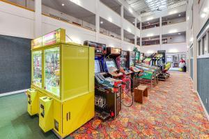 a room with several video game machines on display at Snowshoe Condo with Mtn Views, Walk to Ski Lift in Snowshoe