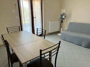 a living room with a table and chairs and a couch at Villa Angela in Mosciano SantʼAngelo +8 photos