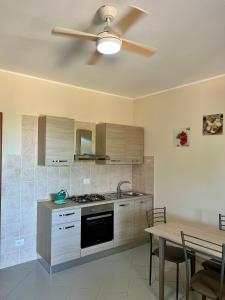 a kitchen with a ceiling fan and a table at Villa Angela in Mosciano SantʼAngelo