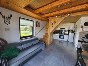 a living room with a couch and a kitchen at Domek Bieszczadzki Staw - Noclegi Czarna in Czarna +43 photos