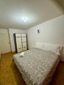 a bedroom with a bed with a phone on it at La Maison de Voyage in Lausanne +1 photo