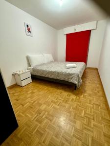 a bedroom with a bed and a red door at La Maison de Voyage in Lausanne