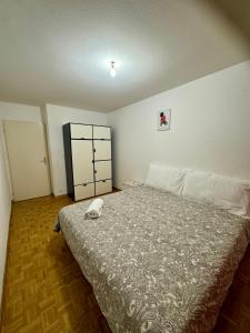 a bedroom with a bed with a phone on it at La Maison de Voyage in Lausanne