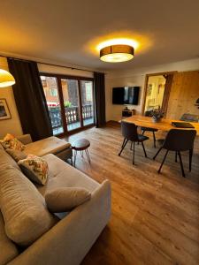 a living room with a couch and a table at s´Bergnestle in Bad Hindelang
