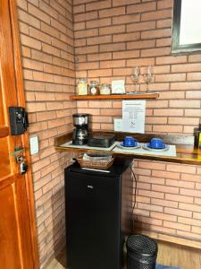 a kitchen with a counter with a coffee maker on it at Vivendas Canaã in Espera Feliz