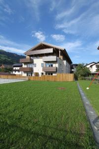 a house with a large lawn in front of it at Apart Resort Rabl in Westendorf