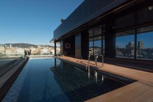 a swimming pool on the side of a building at Negresco Princess 4* Sup in Barcelona