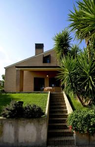 a house with a staircase in front of a house at Residence Costamartino in Vieste