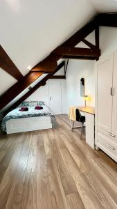 a bedroom with a bed and a desk in a attic at Family-Friendly Duplex - NEAR CENTER - FREE PARKING - WIFI in Colmar