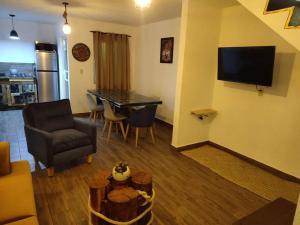 a living room with a couch and a table and a television at Escondite Artesanal Mex in San Francisco Cuautliquixco