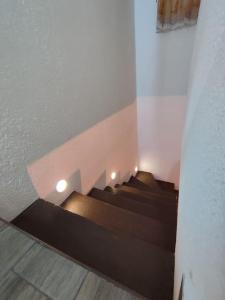 a group of stairs in a building with lights at Escondite Artesanal Mex in San Francisco Cuautliquixco +6 photos