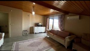 a living room with a couch and a table at Yıldız Pansiyon in Sapanca