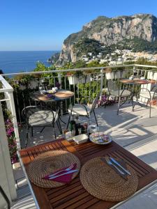 a table on a balcony with a view of the ocean at La Reginella Capri in Capri