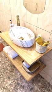 a sink on a wooden table in a bathroom at Chambre Djaou meublée Voidjou in Batsa