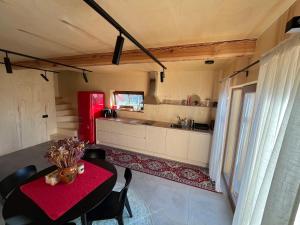 a kitchen with a red table and a red refrigerator at Kur skamba varpai in Berżory +38 photos
