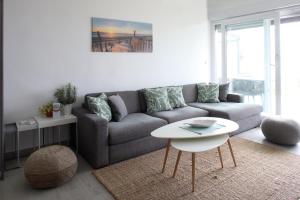 a living room with a couch and a table at Beachfront deluxe apartment in Povljana +22 photos