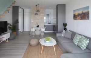 a living room with a couch and a table at Beachfront deluxe apartment in Povljana