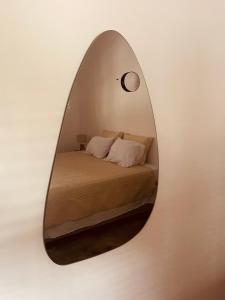 a mirror on a wall with a bed in it at Pindoretama sitio in Pindoretama +48 photos