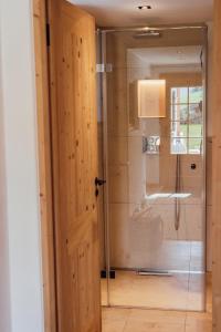 a bathroom with a shower with a glass door at Ferienwohnung Schwarzenberg in Fischbachau