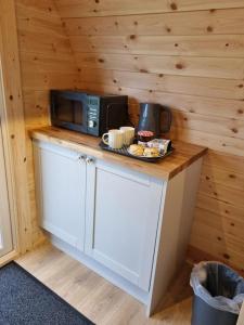 a kitchen with a microwave and a plate of food on a counter at Lavender in Brixham