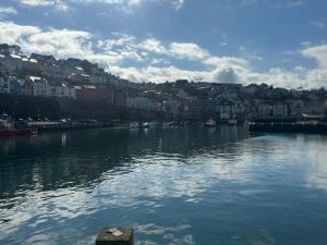 a large body of water with a city in the background at Lavender in Brixham