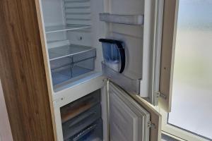an empty refrigerator with its door open in a kitchen at 3-Bed Caravan - Sleeps 8 - Pool in Skegness