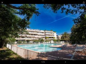 a swimming pool in front of a building at Eden in Saint-Tropez