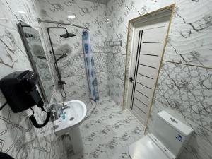 a bathroom with a toilet and a sink at Emirate Plaza in Sergeli +39 photos