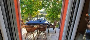 a table and chairs on a balcony with a view at River House in Kalabaka