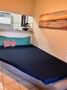 a large bed in a room with a wall at CASA MAR DOCE LAR GOSTOSO - A 150M DA PRAIA in São Miguel do Gostoso +9 photos