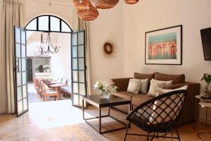 a living room with a couch and a table at The Diplomat Boutique Hotel in Mérida