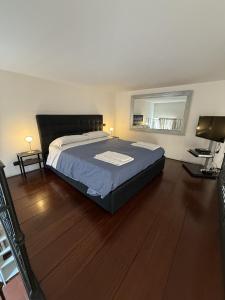 a bedroom with a bed and a mirror on the wall at ROME LUXURY HOUSE - THE SUITE in Rome