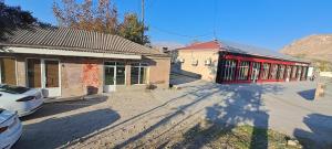 an empty street in front of two buildings at Hasmik house in Areni