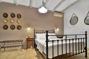 a bedroom with a bed and mirrors on the wall at Niriides Luxury Apartments in Syvota