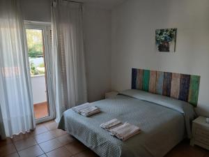 a bedroom with a bed with two towels on it at La casa di ale in Latina +44 photos
