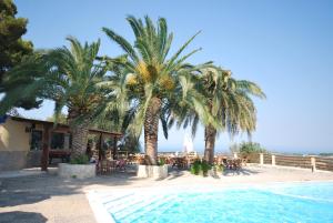a resort with palm trees and a swimming pool at Villaggio Santo Stefano in Vieste