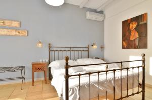 a bedroom with a bed and a painting on the wall at Niriides Luxury Apartments in Syvota