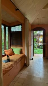 a bedroom with a bed with a laptop on it at Rustic AC Oasis on Ometepe Island in Santa Cruz